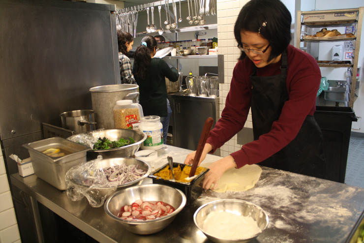 A St. John's College resident helps Green College residents in the kitchen